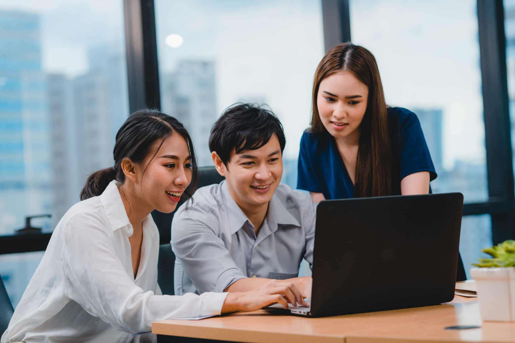 collaborative process multicultural businesspeople using laptop